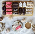 Top view of selection of colorful and delicious cake desserts on tray on table.