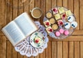 Top view of selection of colorful and delicious cake desserts on tray on table.