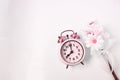 Top view selective focus vintage alarm clock  with beautiful bouquet flowers  on white background. Love anniversary, dating and Royalty Free Stock Photo
