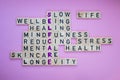 Top view of SELFCARE word on pink background. Minimalism creative crossword puzzle concept. Message of text Slow life