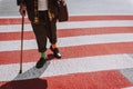 Hipster old man stopping at pedestrian crossing