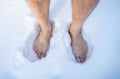 Top view of senior man on snow outdoors, closeup of feet. Unrecognizable guy developing resistance to cold in winter Royalty Free Stock Photo