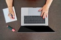 Top view of senior woman using computer at home office while taking notes on a notebook Royalty Free Stock Photo