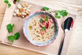 Top view on served cream soup with jamon, parsley and bread on wooen background. Flat lay food for lunch. Copy space for design. Royalty Free Stock Photo