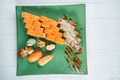 Top view on set of assorted roll and sushi on green plate isolated on white wooden background. Sushi with salmon, eel. japanese Royalty Free Stock Photo