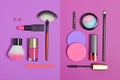 Top view on set of beauty products as decorative cosmetics and makeup brushes on bright purple background