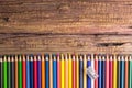 Top view of a set of colored pencils on wooden background with s Royalty Free Stock Photo