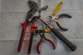 Top view of a set of DIY tools (pliers, hammer, wire cutters, and screwdrivers)
