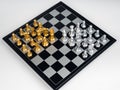 Top view of set of golden and silver chess pieces element, king, queen rook, bishop, knight, pawn standing on chessboard. Royalty Free Stock Photo