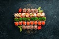 Top view. set of sushi rolls on a black stone plate. Traditional Japanese food. Royalty Free Stock Photo