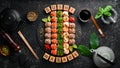 Top view. set of sushi rolls on a black stone plate. Traditional Japanese food. Royalty Free Stock Photo