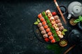 Top view. set of sushi rolls on a black stone plate. Traditional Japanese food. Royalty Free Stock Photo