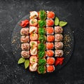 Top view. set of sushi rolls on a black stone plate. Traditional Japanese food. Royalty Free Stock Photo