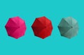 Top view, Set three colours umbrella isolated on cyan background, stock photo, invesment, business, summer concept, red pink dark Royalty Free Stock Photo