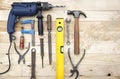 Top view set of tools consisting of drill, hammer and other joinery accessories placed on natural pine wood workbench Royalty Free Stock Photo