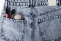 Top view of blue jeans and decorative cosmetic products in the back pocket.Concept of fashion lifystyle Royalty Free Stock Photo