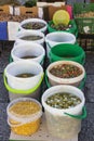 Top view of several different types of olives in translucid cups in the street market