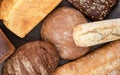 Top view of several loaves of bread over a wooden background Royalty Free Stock Photo