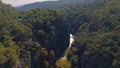 Top view of shallow river bed between green rocks. Mountain landscape. Wildlife. Tourism. Ecology