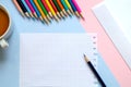 Top view of a sheet of paper, colored pencils, an envelope and a Cup of tea on the table. Royalty Free Stock Photo