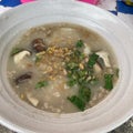 Top view, shiitake mushroom porridge with minced pork and fresh vegetables, Asian food concept. Royalty Free Stock Photo