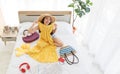 Top view shot of Asian young happy female traveler wears big hat laughing smiling look at camera sitting trying on yellow summer Royalty Free Stock Photo