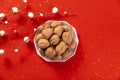 Top view shot of a bowl of walnuts on a beautiful red Christmas background