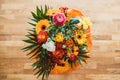 Top view shot of a bunch of colorful flowers on a wooden table