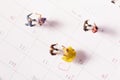 Top view shot of cute dancing figurines on a calendar - concept of Valentine