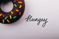Top view shot of a donut next to a Hungry text - concept of hunger