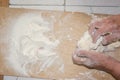 Top view shot of female hands mixing dough. Female hands knead dough on wooden board. Royalty Free Stock Photo