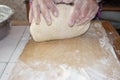 Top view shot of female hands mixing dough. Female hands knead dough on wooden board. Royalty Free Stock Photo