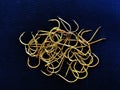 Top view shot of gold fishing tackles on a blue knitted background