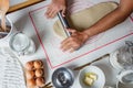 Top view shot of hands of Hispanic baker making cinnamon rolls