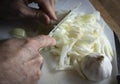 Top view shot of a man cutting onion on a cutting board Royalty Free Stock Photo