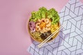 Top view shot of organic poke bowl with chopsticks placed on a textured background Royalty Free Stock Photo