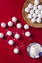 Top view shot of preparation of Chinese sweet dumplings on a red background Royalty Free Stock Photo