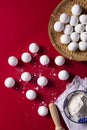 Top view shot of preparation of Chinese sweet dumplings on a red background Royalty Free Stock Photo