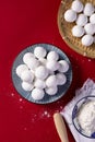 Top view shot of preparation of Chinese sweet dumplings on a red background Royalty Free Stock Photo