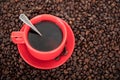 Top view shot of a small bag of coffee beans and coffee beans scattered in a spoon on a white background Royalty Free Stock Photo