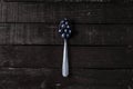 Top view shot of a spoon of blueberries, wooden table background Royalty Free Stock Photo