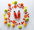 Top view shot of tropical cold drink mixed juice bottle with sliced raw ripe fresh fruits apple orange lemon and passion fruit Royalty Free Stock Photo