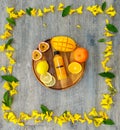 Top view shot of tropical cold drink mixed juice bottle with sliced raw ripe fresh fruits mango orange lemon and passion fruit Royalty Free Stock Photo