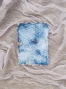 Top view shot of a weathered old blue wedding invitation on white bride vail Royalty Free Stock Photo