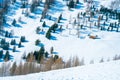 Top view shot of a winter ski resort, a snowy landscape with green trees Royalty Free Stock Photo