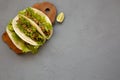 Top view, shrimp tacos on a rustic wooden board on a gray background. Flat lay, from above, overhead. Mexican cuisine. Copy space