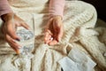 Top view Sick woman hold in hands medicine, pills and glass of water