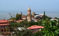 Top view of Signagi town in Georgia, Kahety region, roofs, church tower and fortress with green tress on the background
