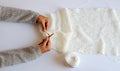 Top view simple concept in gentles color, woman hand knit white scarf for handmade seasonal gift