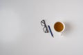 a top view of a simple desk office table desk workplace with hot cup of tea, pen and glasses, copy space Royalty Free Stock Photo
